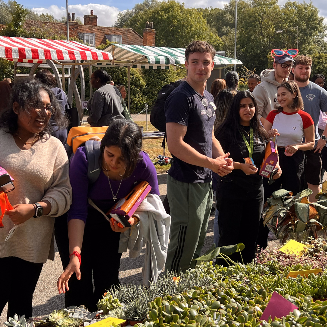 Students buying plants at the Welcome Fair
