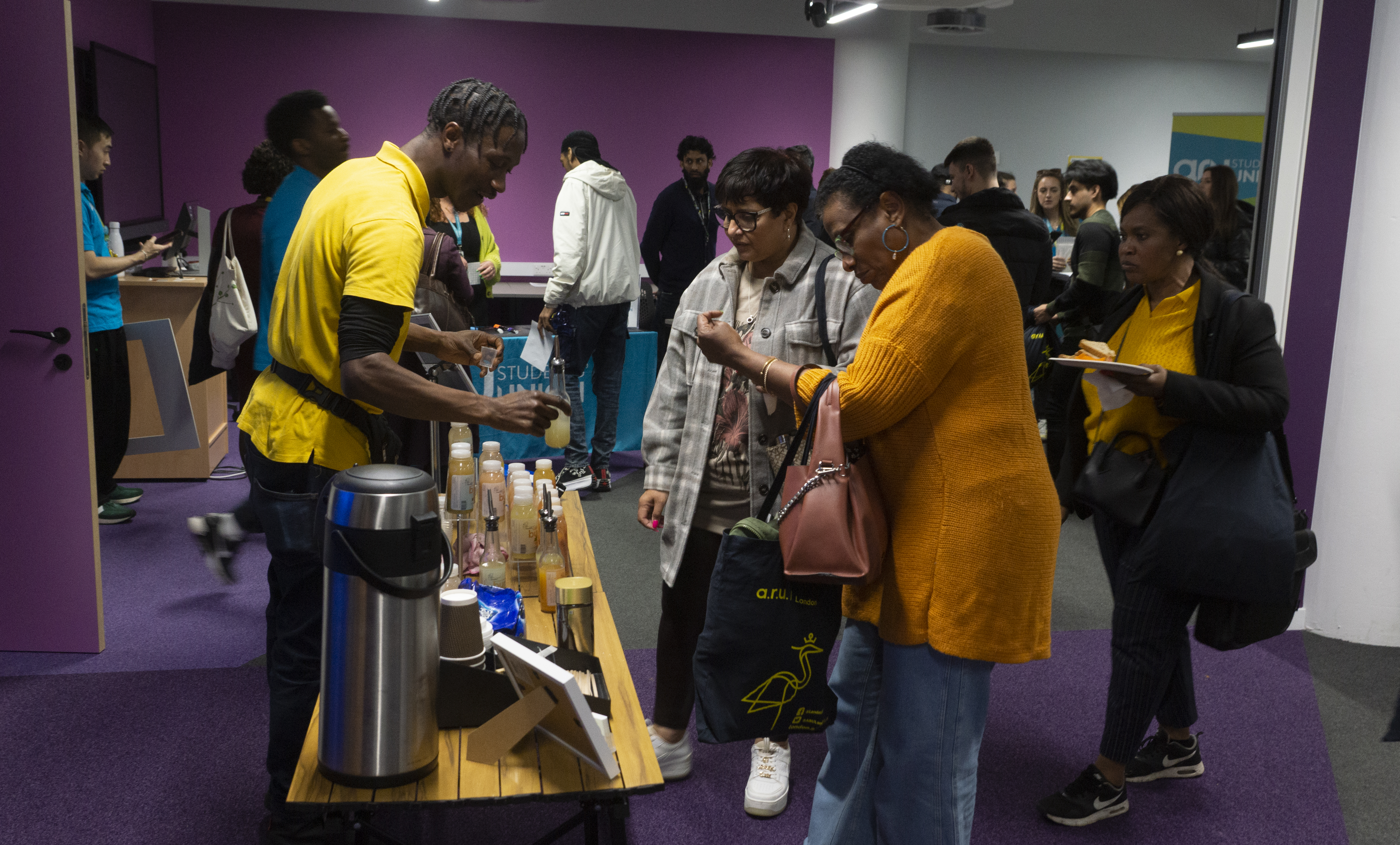 Students chatting at a Welcome Fair stall